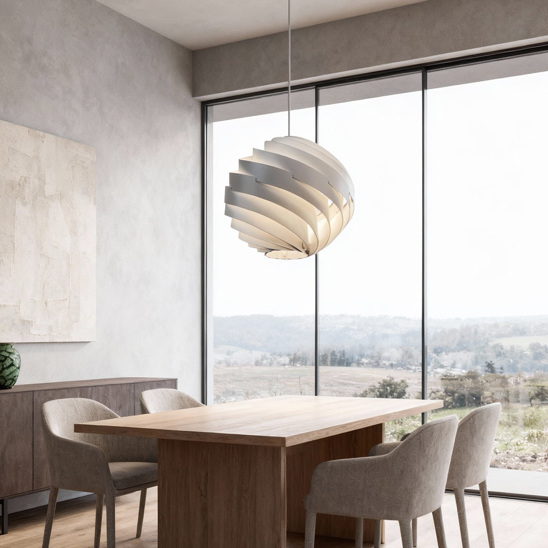 Aureon swirl pendant light in a dining room, sculptural spiral ceiling light above the table