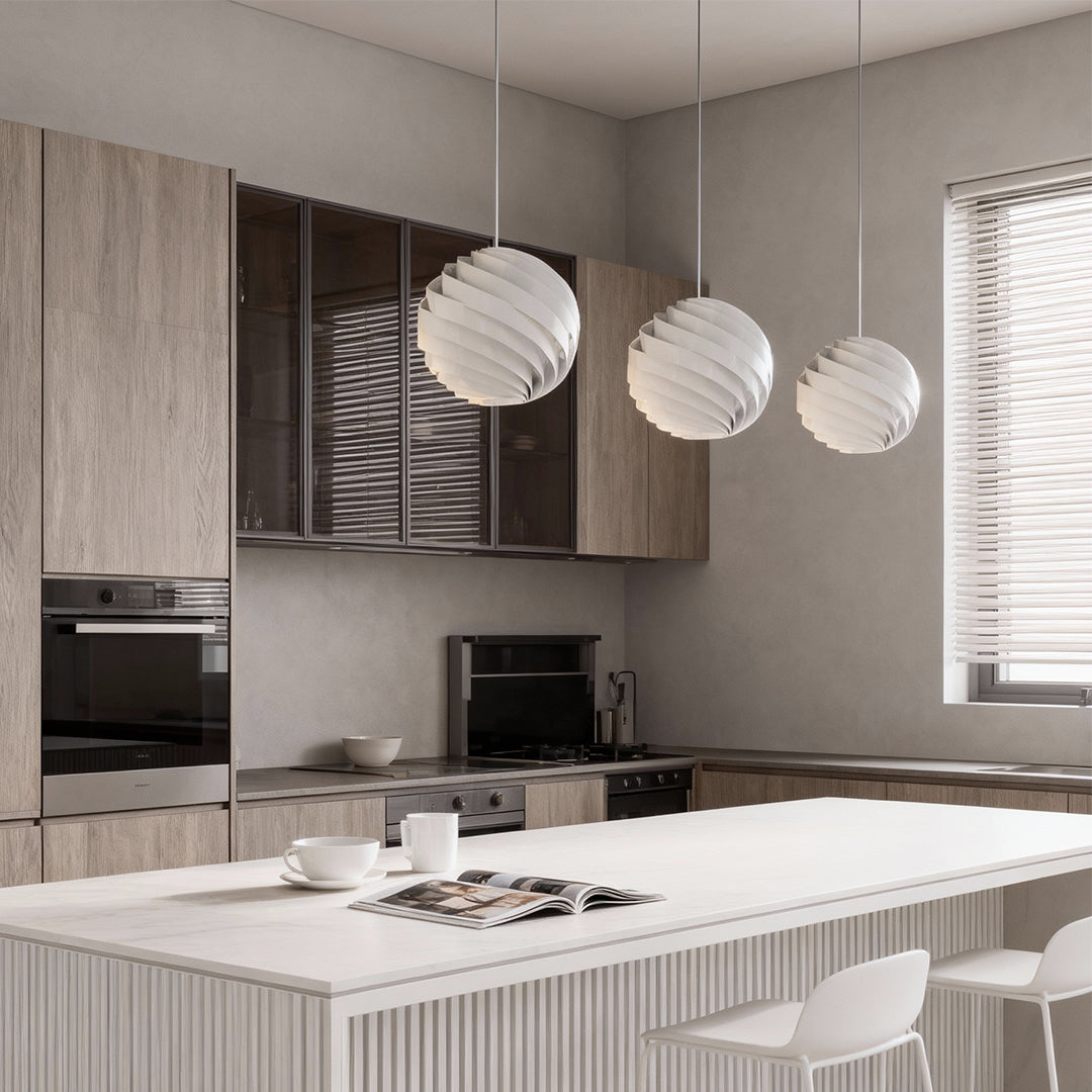 Aureon swirl pendant light hanging over a dining table, modern aluminium spiral light