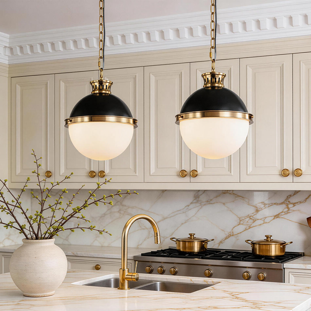 Aureon black iron glass globe pendant light above a kitchen island with warm ambient glow