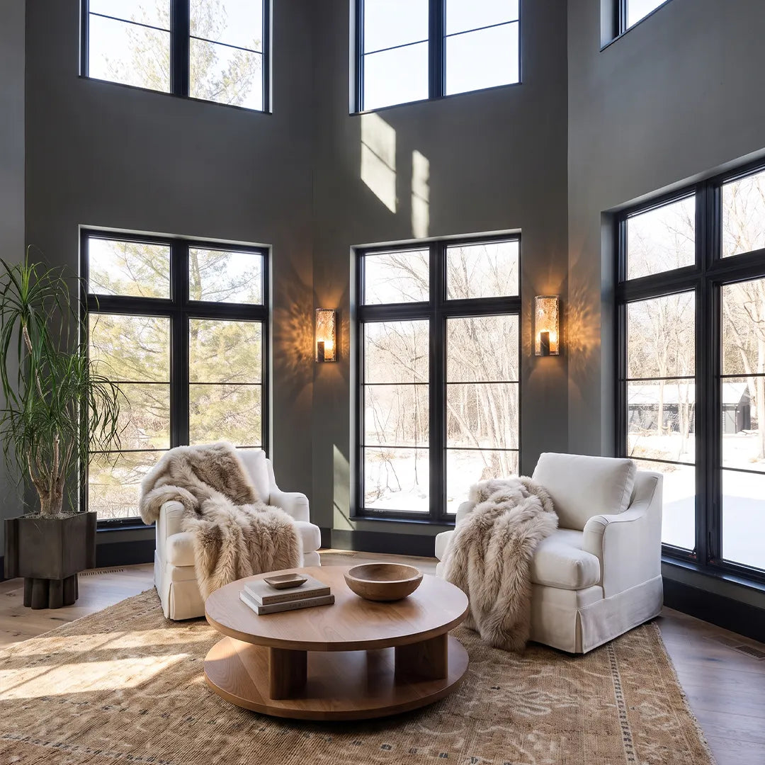 Niva decorative glass wall sconce installed in a double-height living room interior