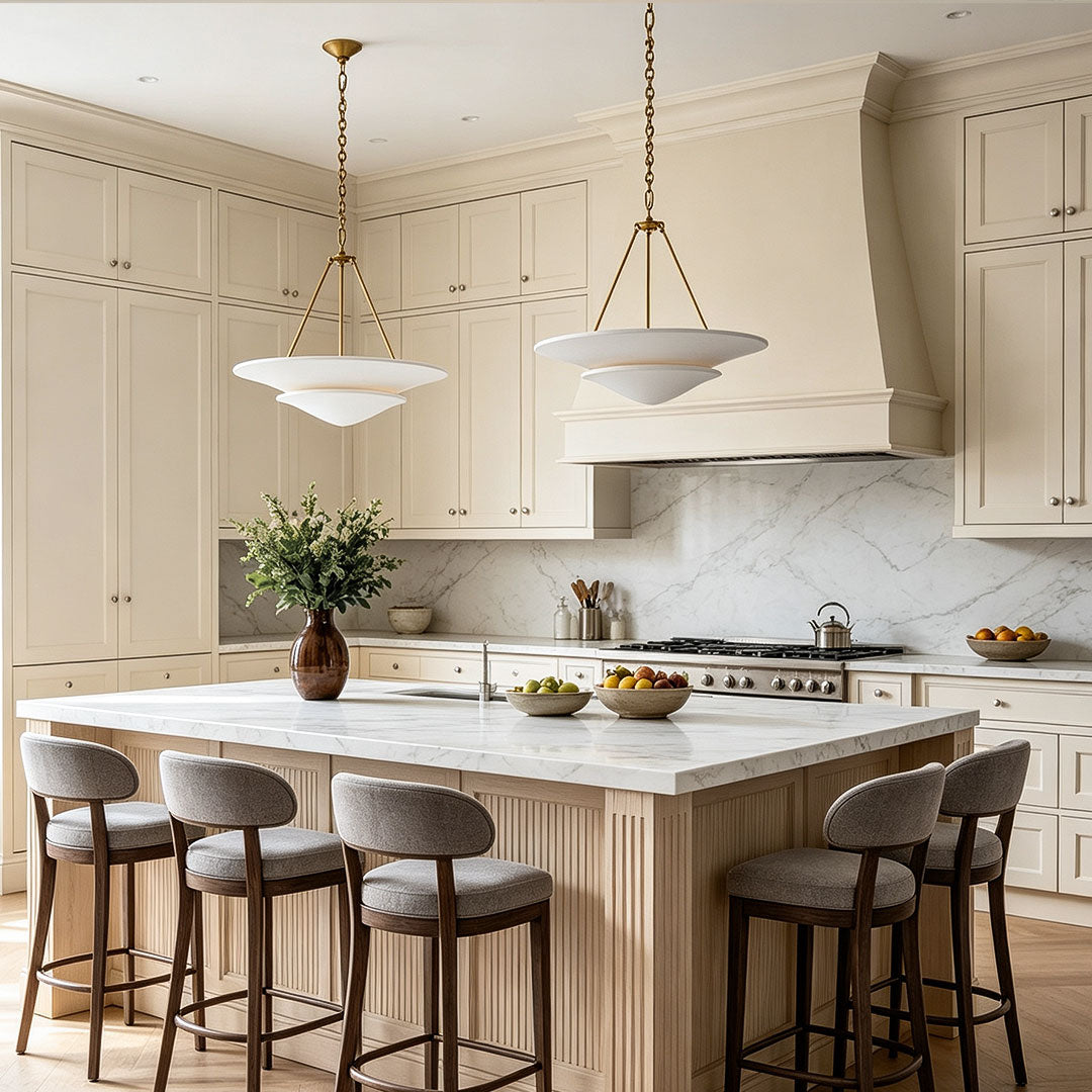 White plaster chandelier positioned above a kitchen island
