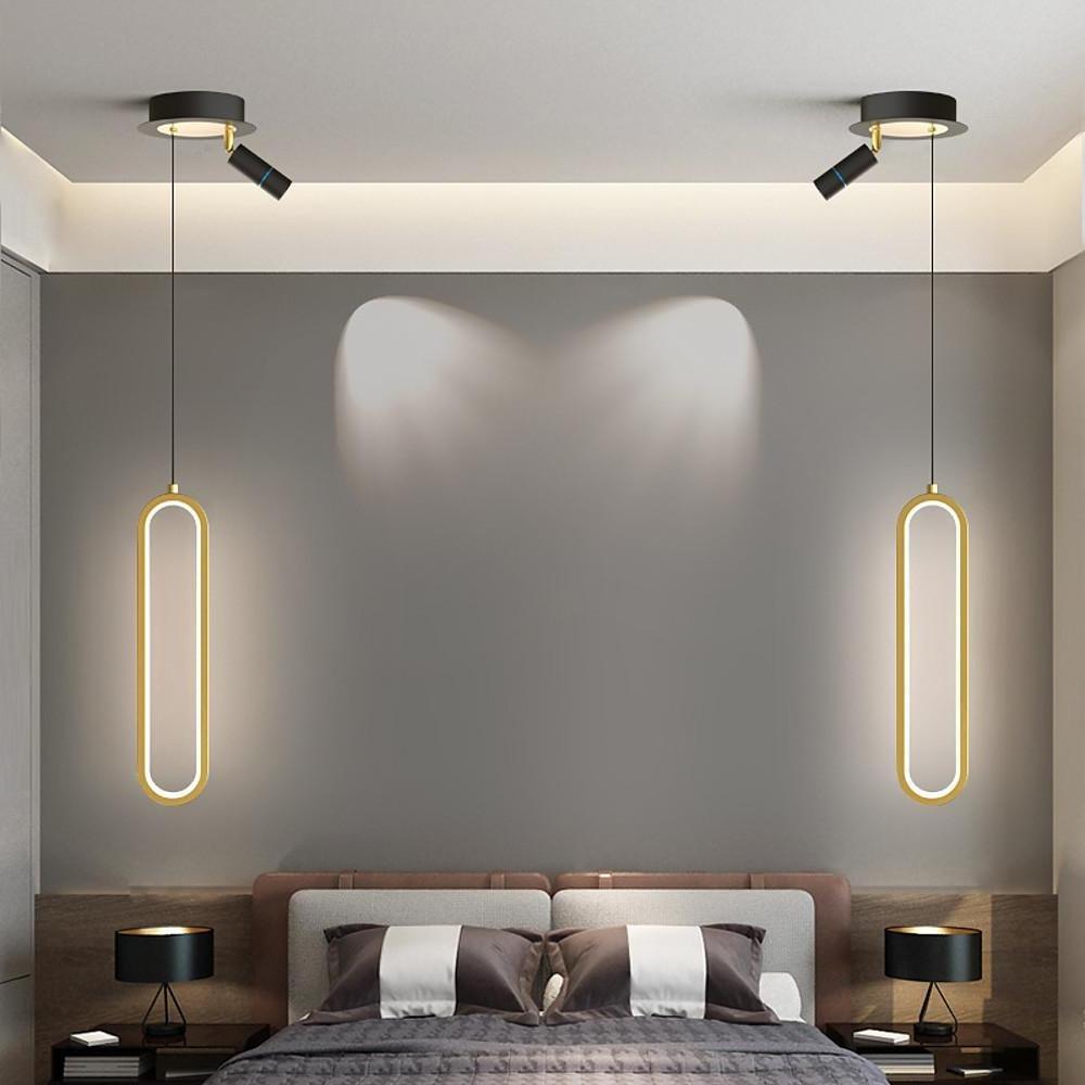 Aureon elongated pendant light in black above a modern dining table, warm white light output