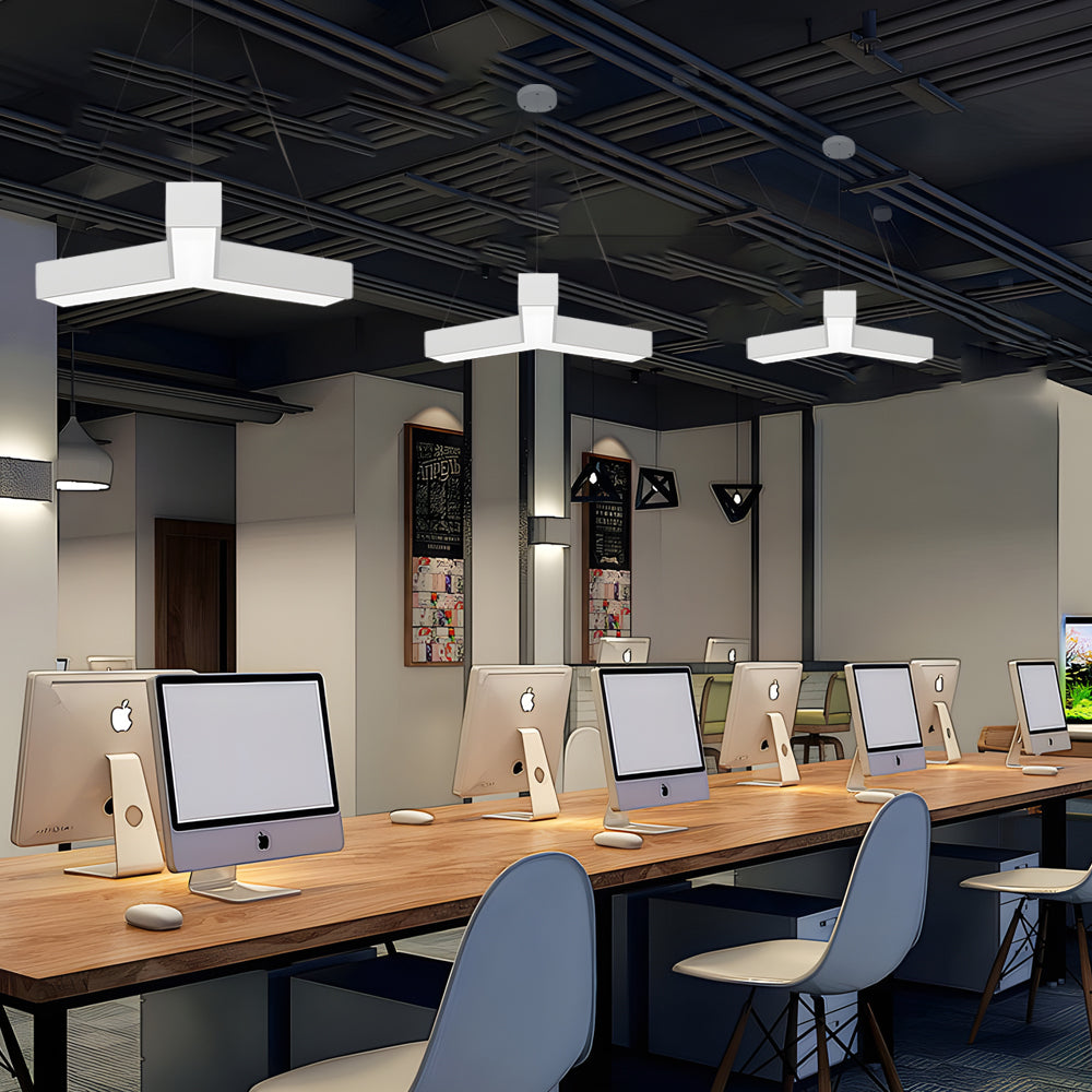 Modular Y-shaped linear pendant light arrangement across an open office workspace ceiling