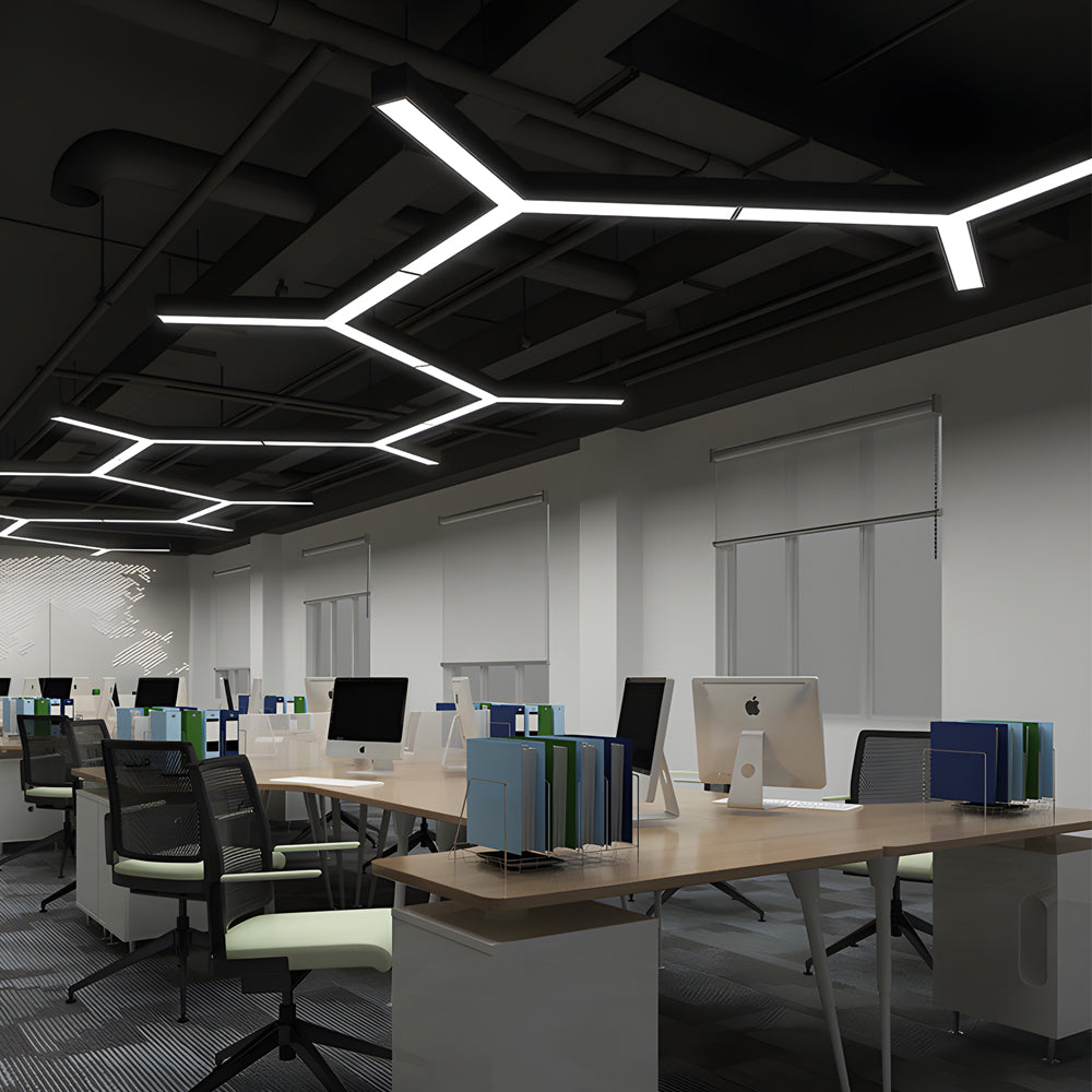 Y-shaped linear pendant light in a modern open-plan office ceiling installation